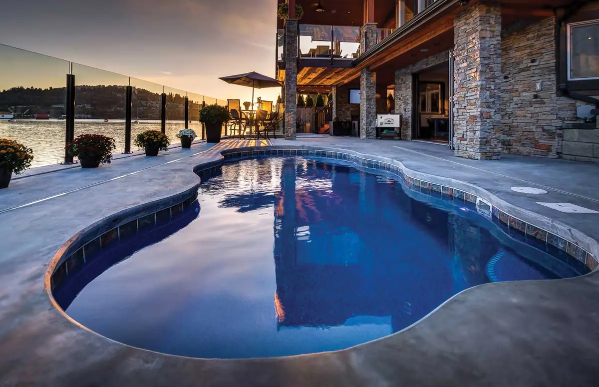 Jamaica 14 freeform fiberglass pool installed in a landscaped backyard